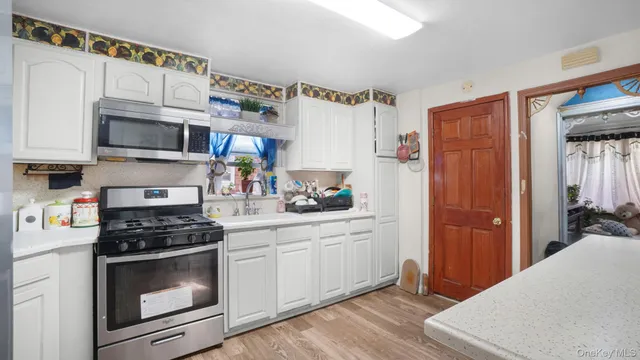 a kitchen with stainless steel appliances granite countertop a refrigerator sink and cabinets