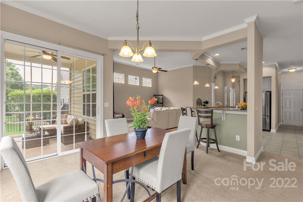 932 Treasure Court Fort Mill, SC 29708 - Photo 11 of 34 a view of a dining room with furniture a chandelier and wooden floor