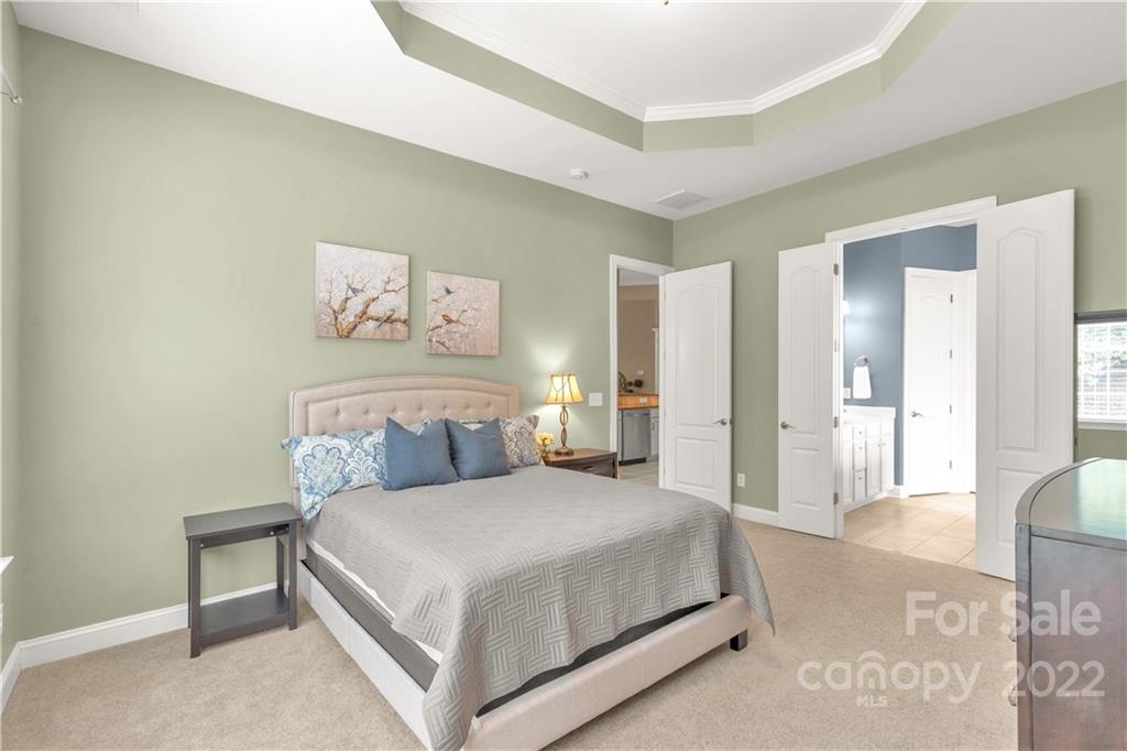 932 Treasure Court Fort Mill, SC 29708 - Photo 12 of 34 a bedroom with a bed and a painting on the wall