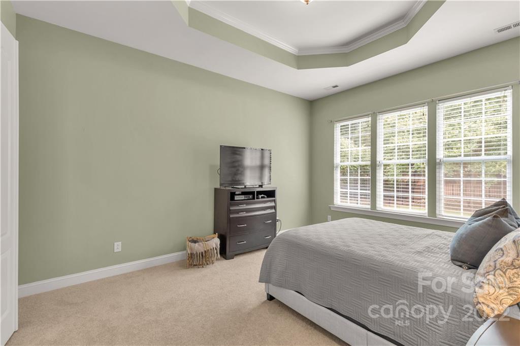932 Treasure Court Fort Mill, SC 29708 - Photo 13 of 34 a bedroom with a bed and a television