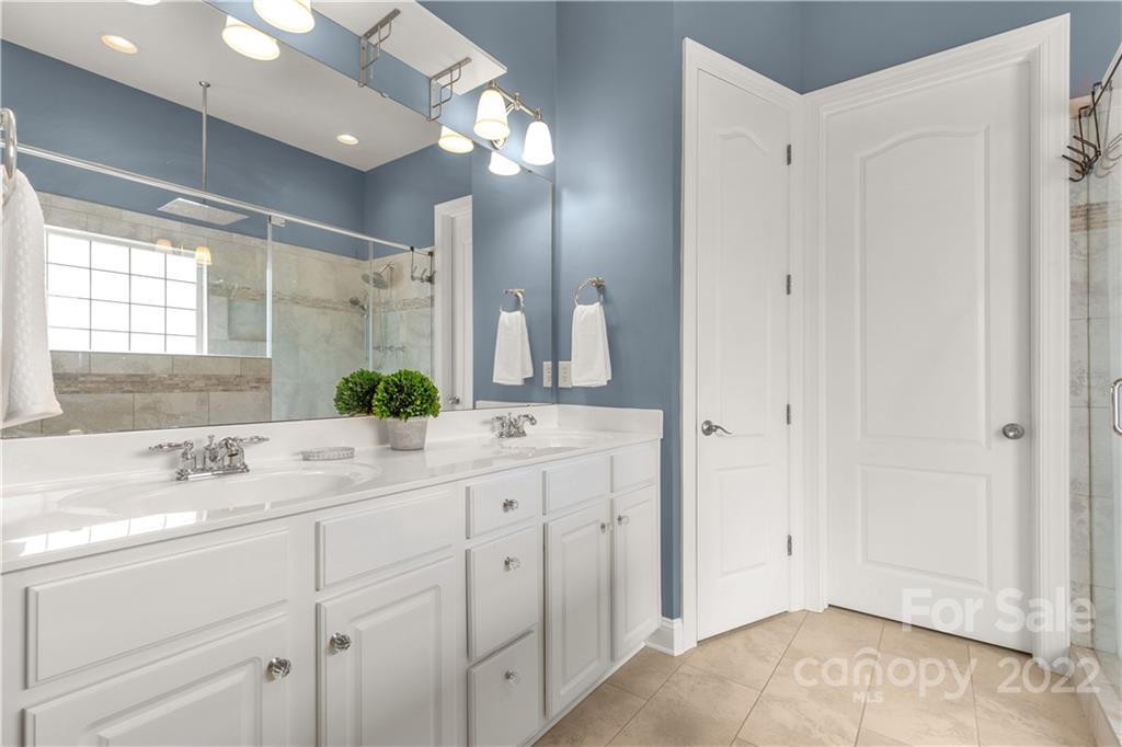 932 Treasure Court Fort Mill, SC 29708 - Photo 14 of 34 a bathroom with a double vanity sink mirror and next to a window