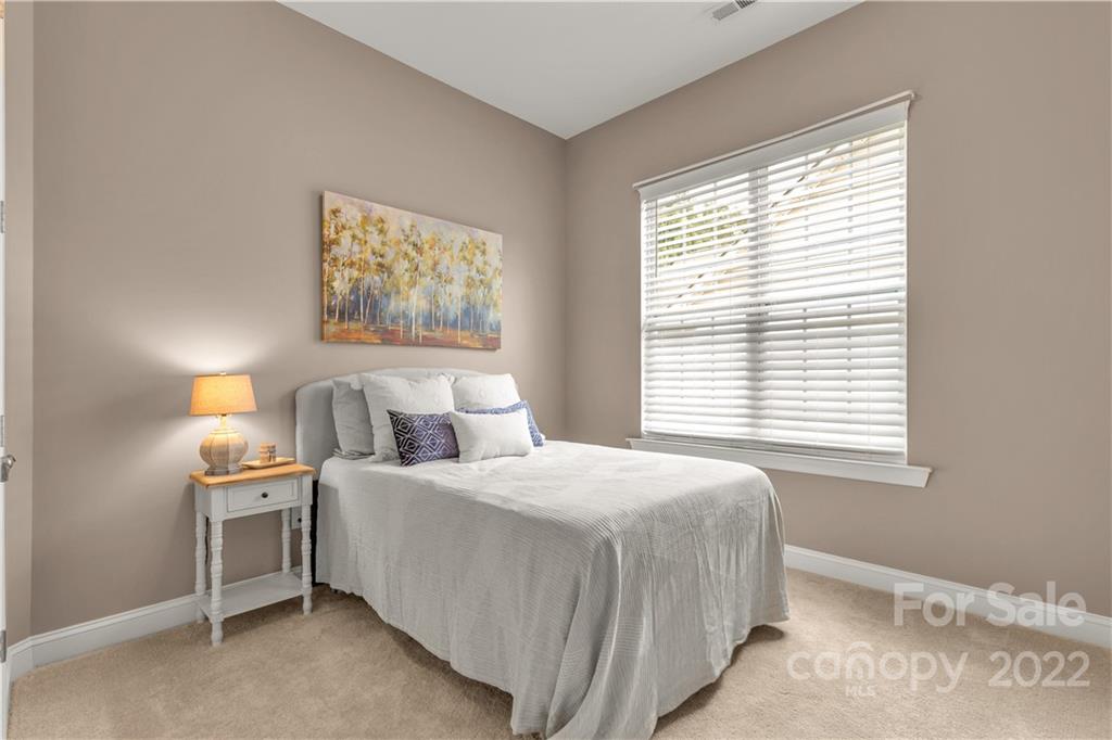 932 Treasure Court Fort Mill, SC 29708 - Photo 17 of 34 a bedroom with a bed and a window