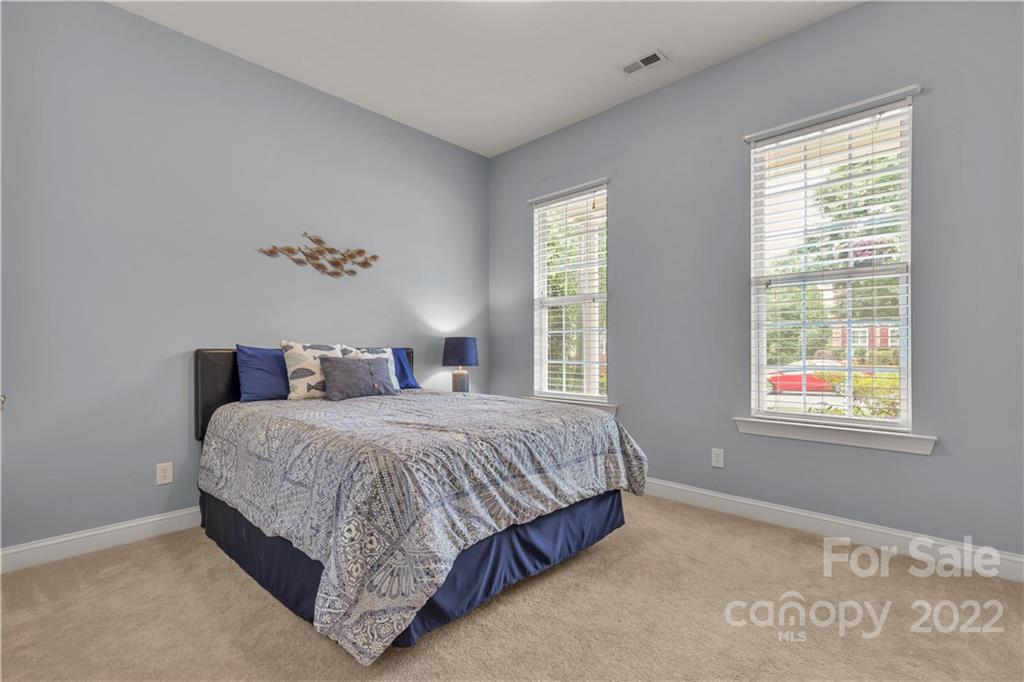932 Treasure Court Fort Mill, SC 29708 - Photo 18 of 34 a bedroom with a bed lamp and window