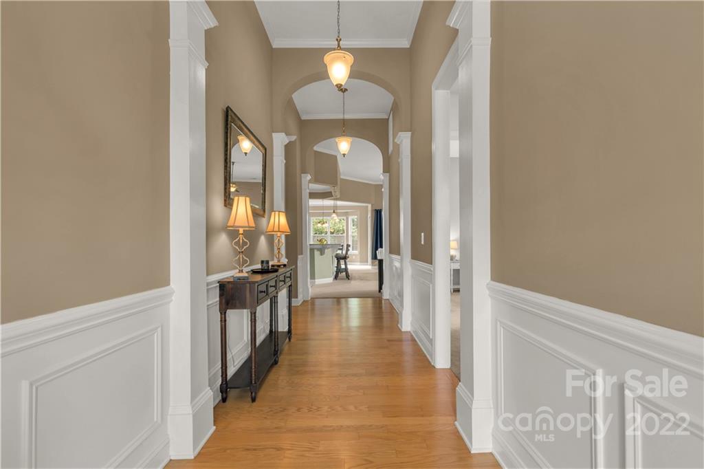 932 Treasure Court Fort Mill, SC 29708 - Photo 3 of 34 a view of a hallway with a dining table & chairs