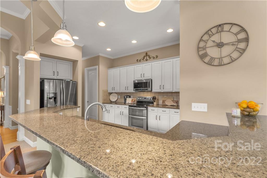 932 Treasure Court Fort Mill, SC 29708 - Photo 5 of 34 a large kitchen with kitchen island a large counter space and stainless steel appliances