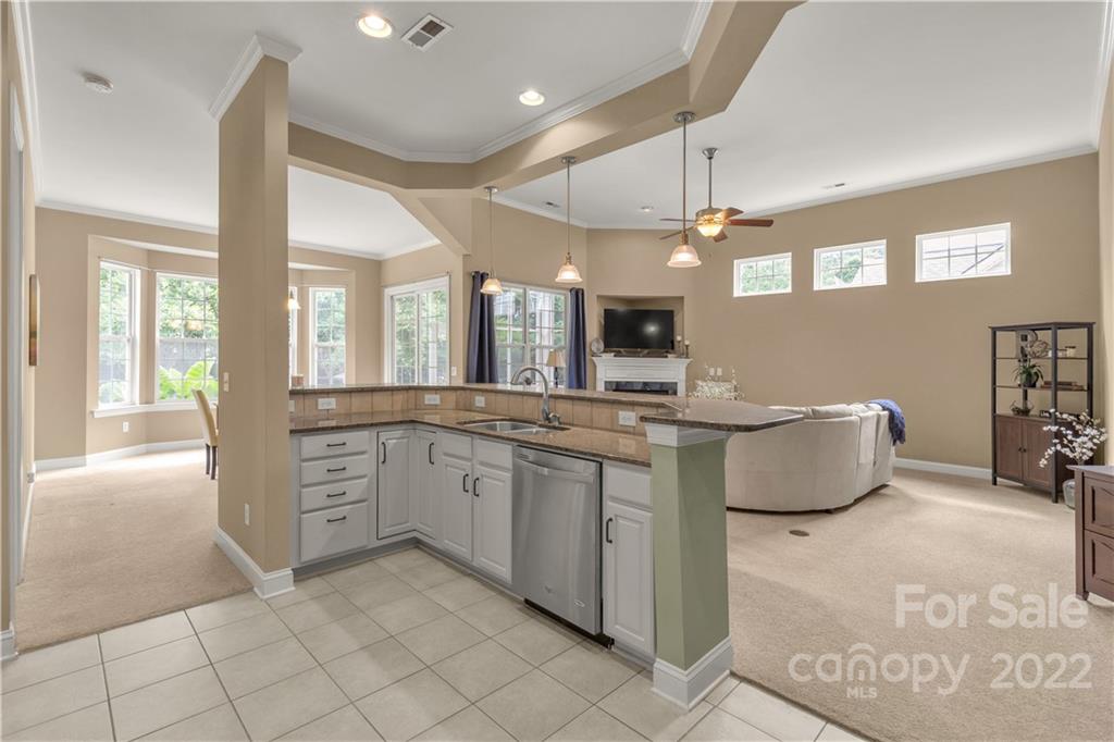 932 Treasure Court Fort Mill, SC 29708 - Photo 6 of 34 a kitchen with granite countertop a sink and white cabinets