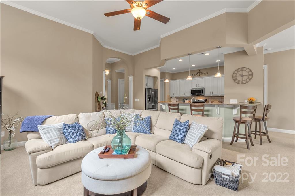 932 Treasure Court Fort Mill, SC 29708 - Photo 7 of 34 a living room with furniture kitchen view and a chandelier