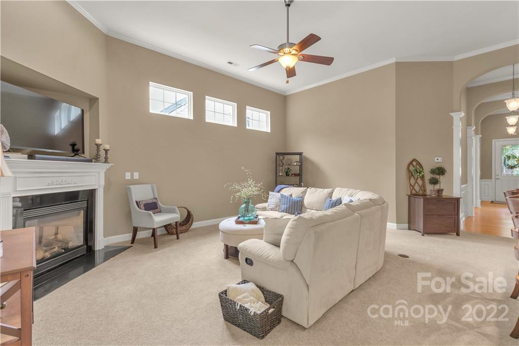 932 Treasure Court Fort Mill, SC 29708 - Photo 8 of 34 a living room with furniture a fireplace and a flat screen tv