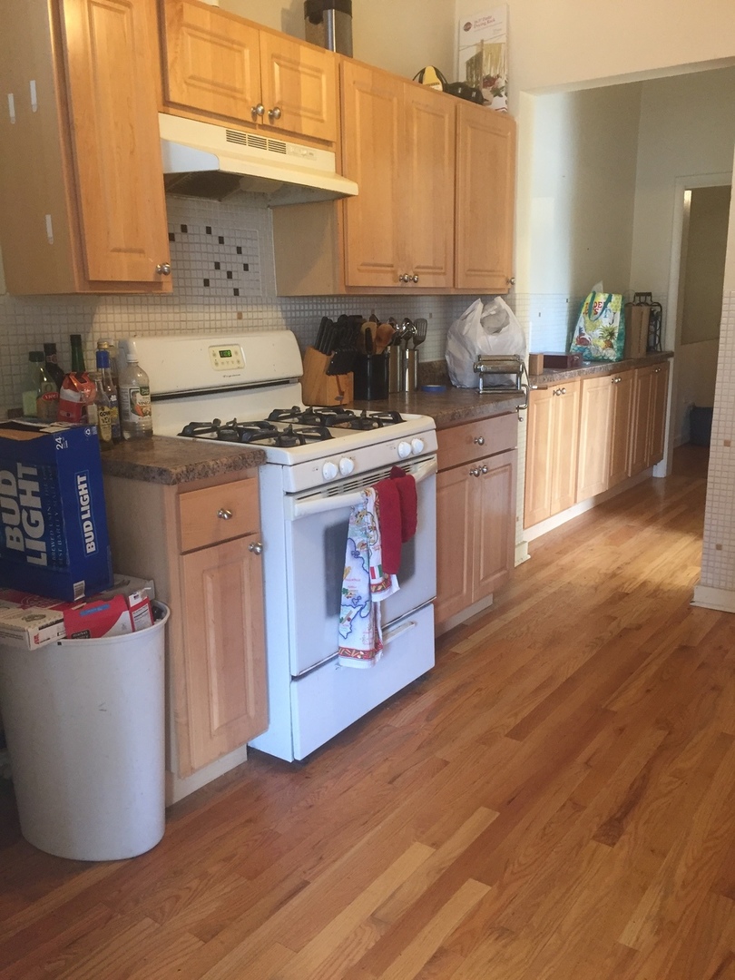 1101 West Pratt Boulevard, Unit 2E Chicago, IL 60626 - Photo 4 of 4 a kitchen with a stove top oven and cabinets
