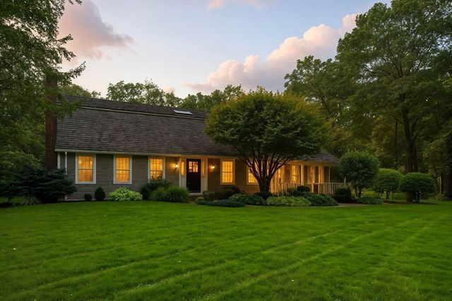 a front view of house with yard and green space
