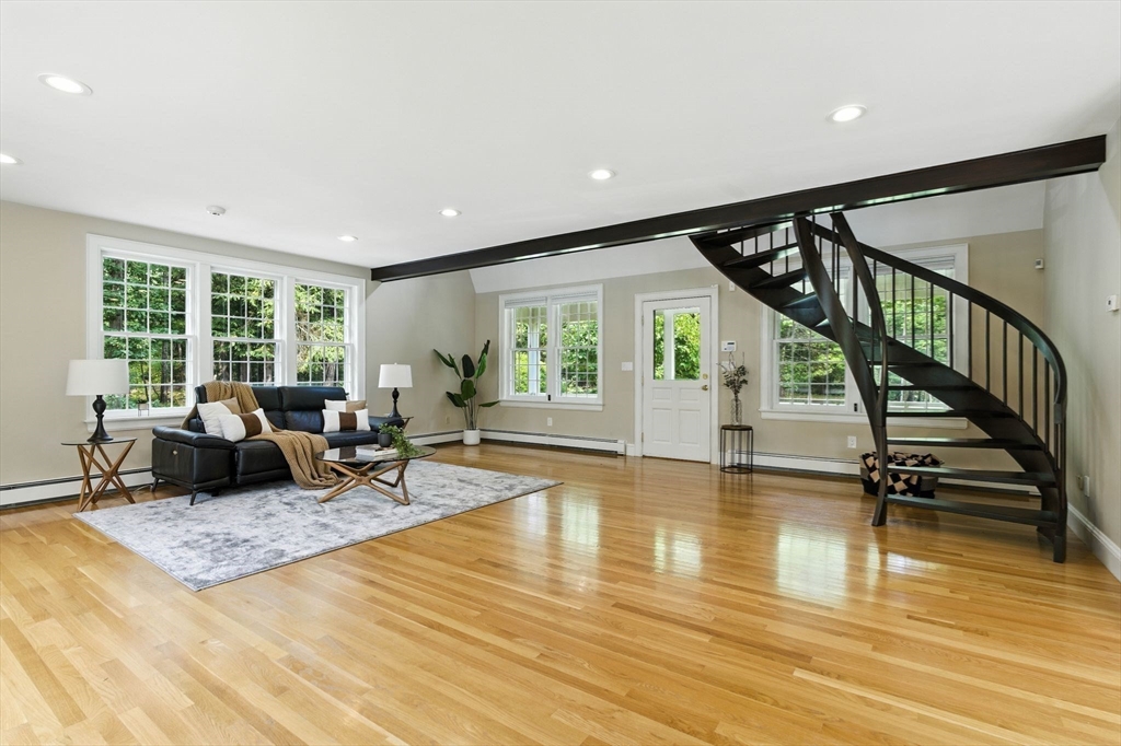 28 Janes Road Boxford, MA 01921 - Photo 29 of 41 a living room with furniture floor to ceiling window and wooden floor