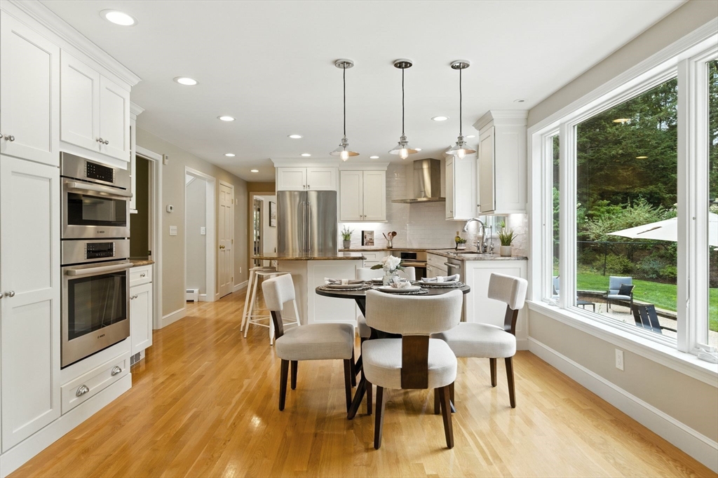 28 Janes Road Boxford, MA 01921 - Photo 3 of 41 a dining room with stainless steel appliances kitchen island granite countertop a stove a kitchen island a dining table and chairs