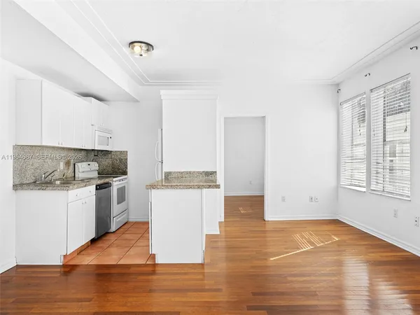 a kitchen with granite countertop a stove and a refrigerator