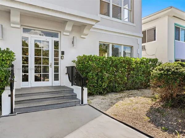 a view of a house with potted plants