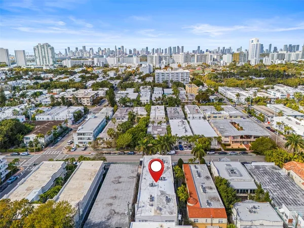 a front view of multiple houses with yard