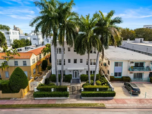 front view of a residential houses with a yard and palm trees
