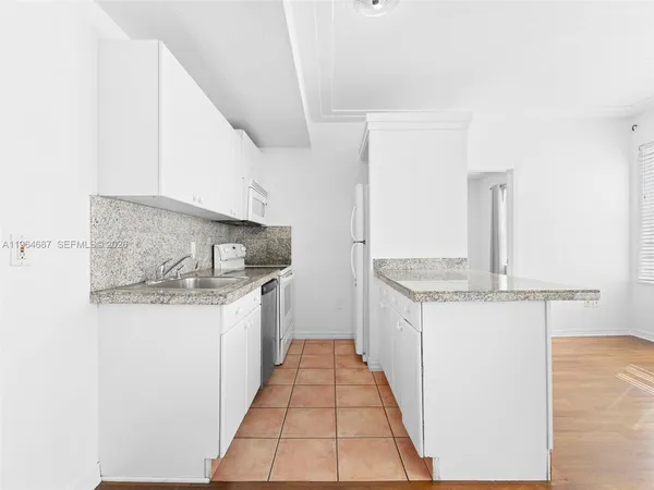 a kitchen with a sink and cabinets