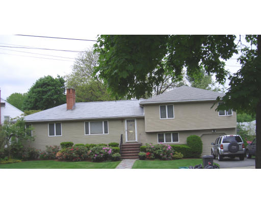 27 Wendell Road Newton, MA 02459 - Photo 1 of 1 a front view of a house with a garden