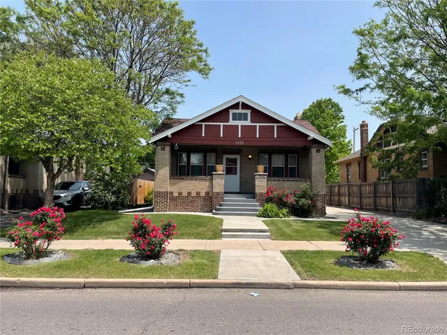a front view of a house with a yard table and chairs