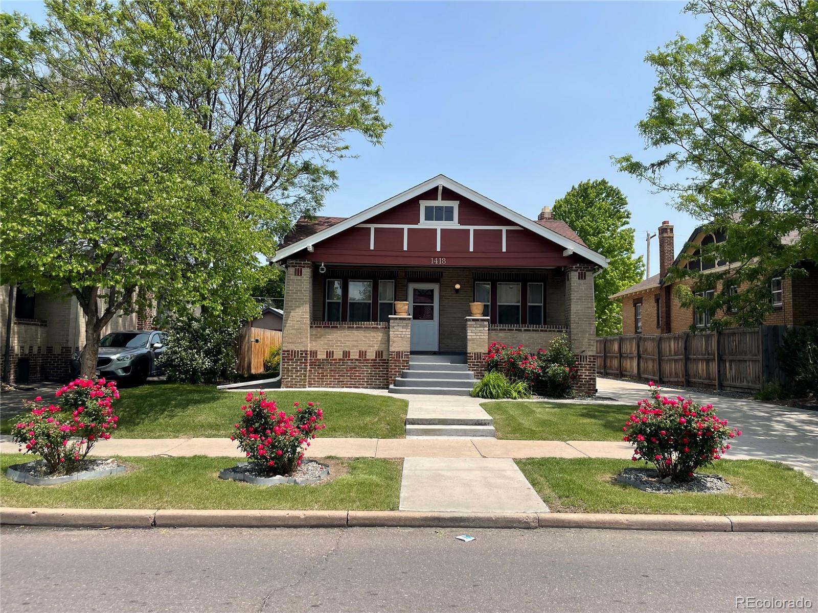 a front view of a house with a yard table and chairs
