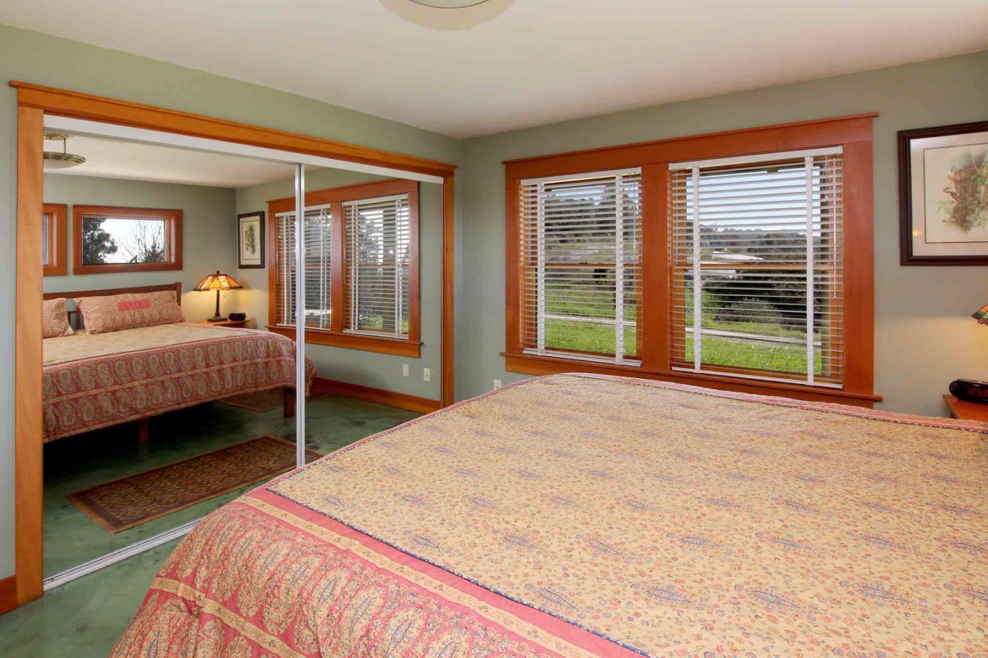 266 Webb Road Watsonville, CA 95076 - Photo 16 of 40 a bedroom with a large bed and two large window