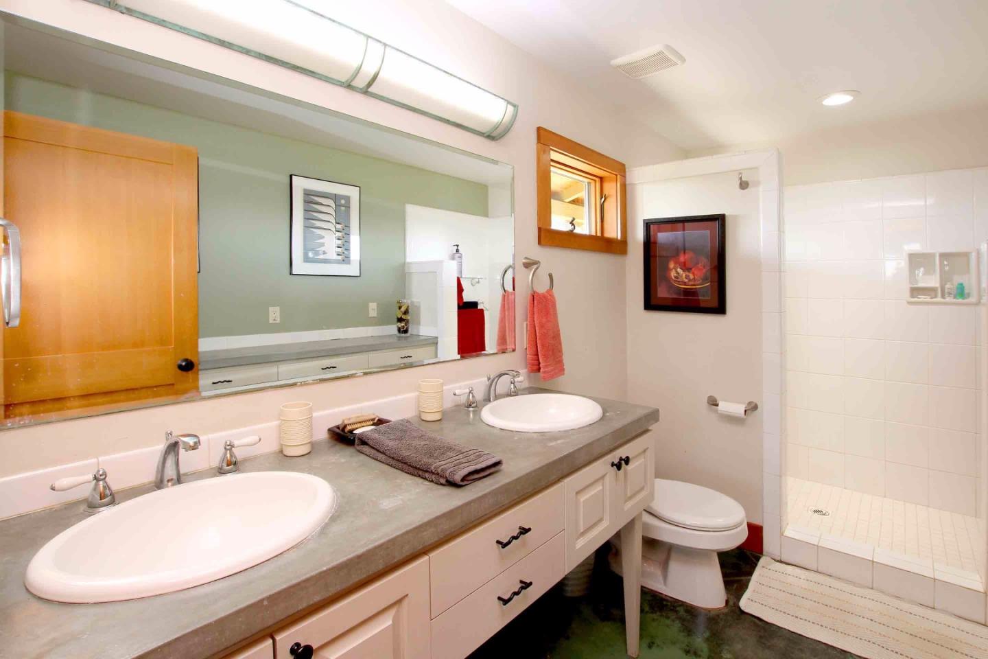 266 Webb Road Watsonville, CA 95076 - Photo 17 of 40 a bathroom with a double vanity sink and a mirror