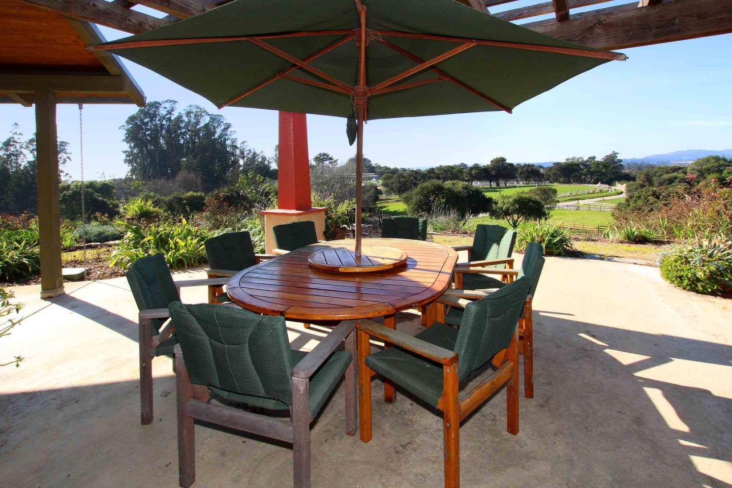 266 Webb Road Watsonville, CA 95076 - Photo 20 of 40 a view of a patio with a table chairs and a umbrella