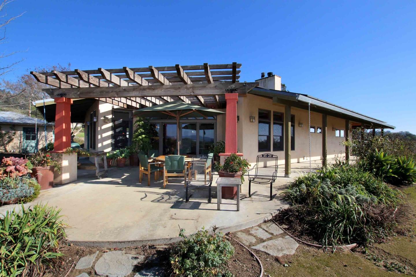 266 Webb Road Watsonville, CA 95076 - Photo 21 of 40 a view of a patio with table and chairs potted plants and floor to ceiling window