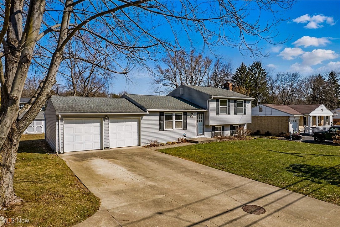 803 Renninger Road Akron, OH 44319 - Photo 2 of 44 Split level home with driveway, a front lawn, a garage and overflow parking driveway.