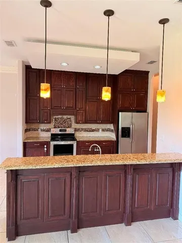a kitchen with a stove a sink and a refrigerator