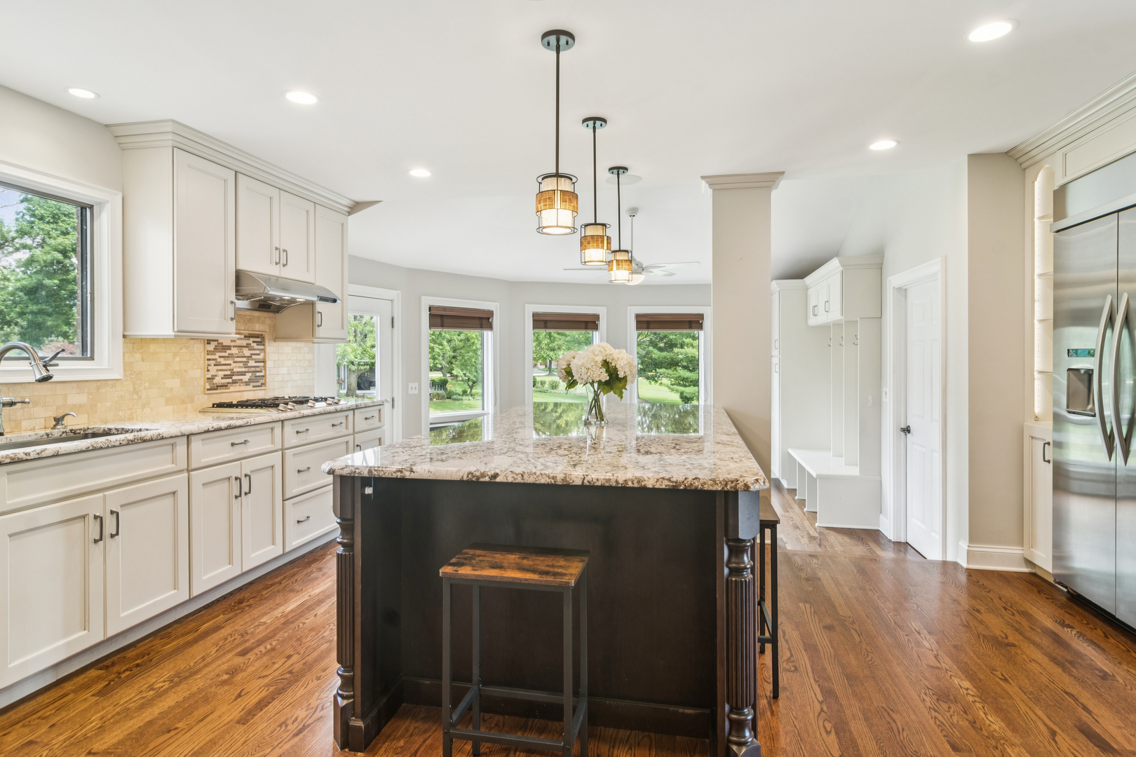 2223 Shetland Road Inverness, IL 60010 - Photo 5 of 40 a kitchen with stainless steel appliances granite countertop wooden floor window and cabinets