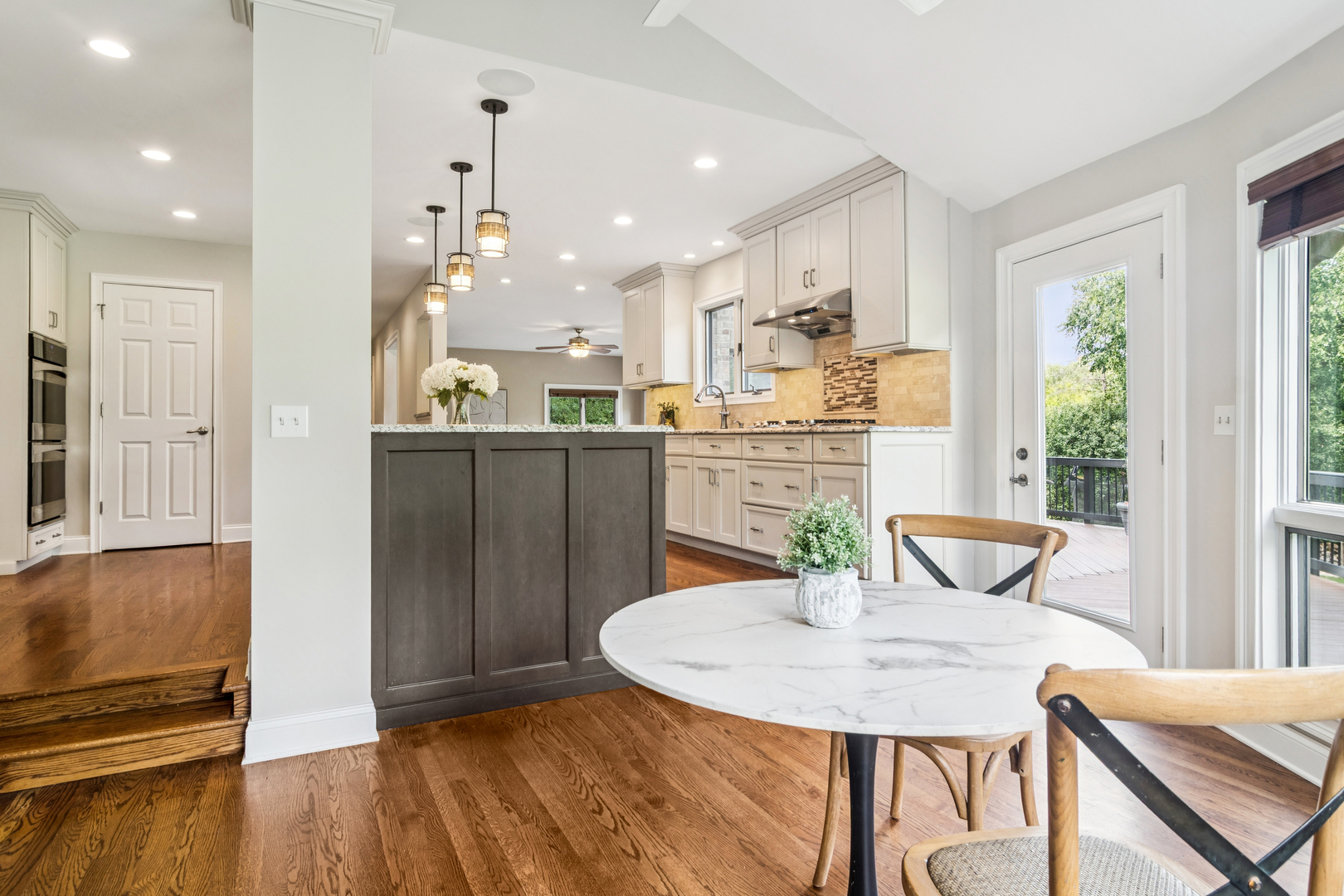 2223 Shetland Road Inverness, IL 60010 - Photo 8 of 40 a kitchen with stainless steel appliances a dining table chairs and wooden floor