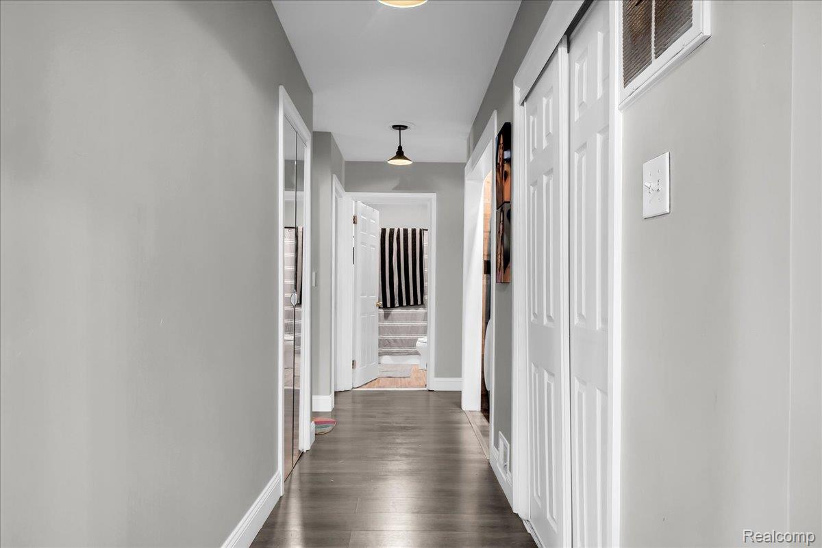 3260 Isabelle Street Inkster, MI 48141 - Photo 7 of 35 Hallway featuring wood-finish flooring and light gray painted walls