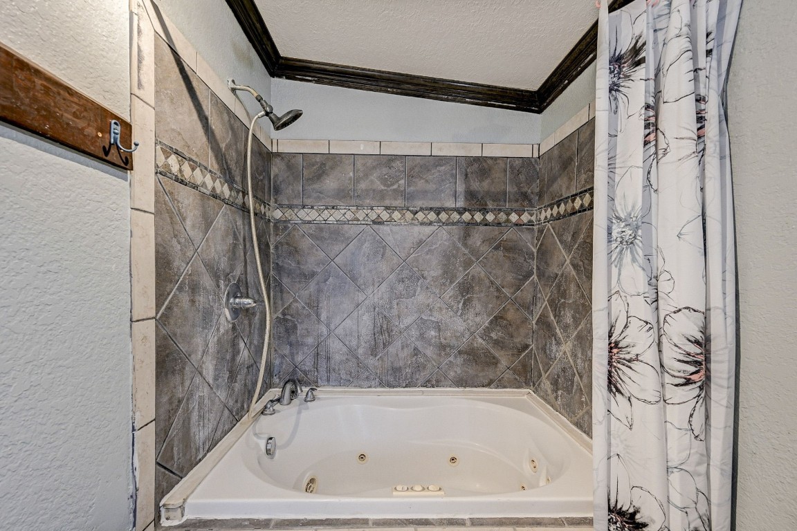 858 Big Hawg Road Trinity, TX 75862 - Photo 16 of 45 a bathroom with a bathtub and shower