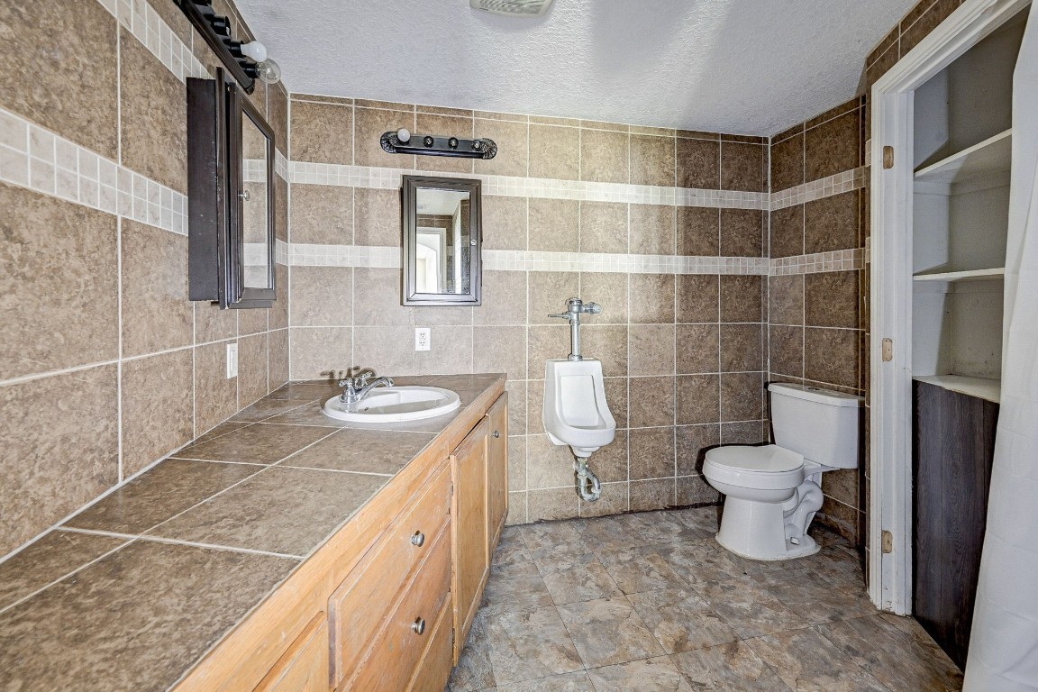 858 Big Hawg Road Trinity, TX 75862 - Photo 24 of 45 a bathroom with a granite countertop sink toilet and shower