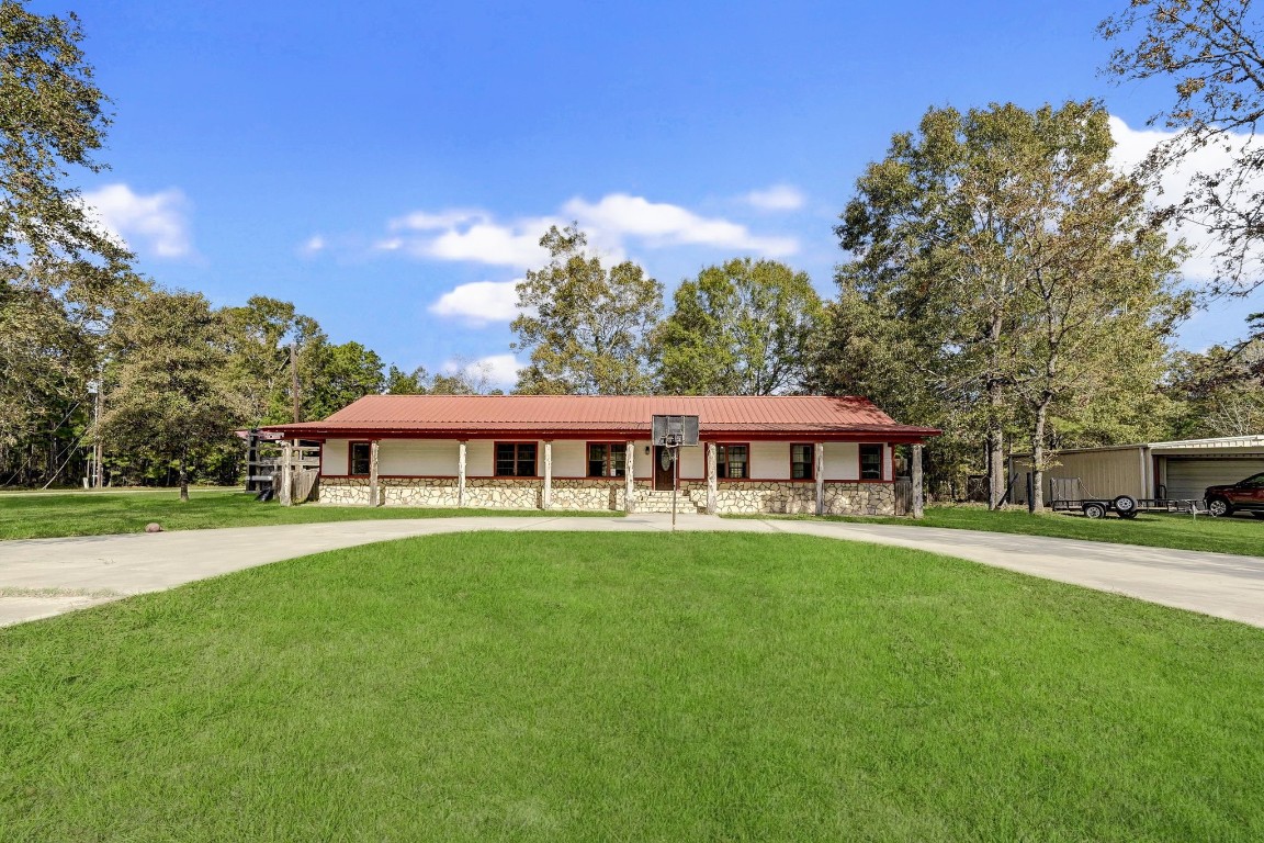 858 Big Hawg Road Trinity, TX 75862 - Photo 3 of 45 a front view of a house with a garden