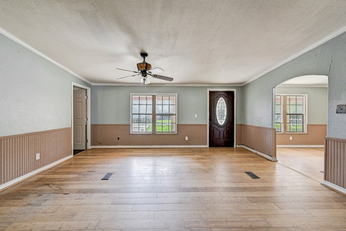 858 Big Hawg Road Trinity, TX 75862 - Photo 9 of 45 a view of an empty room with a window and wooden floor