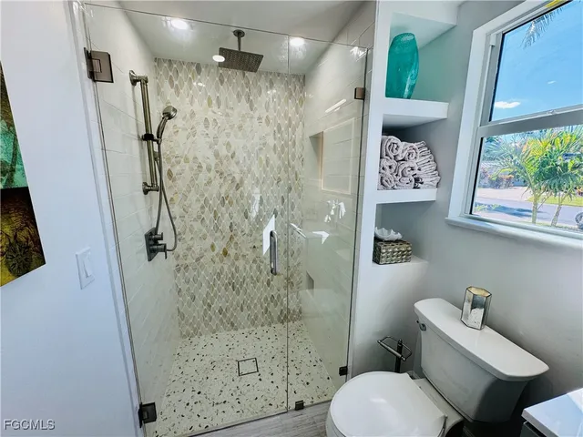 a bathroom with a shower toilet and sink