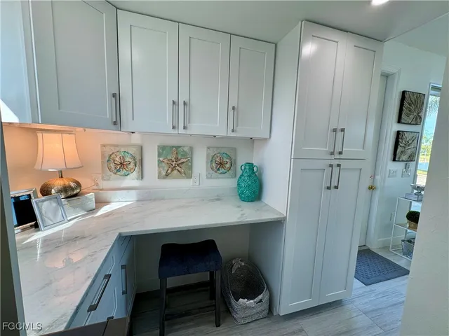 a kitchen with stainless steel appliances granite countertop a sink refrigerator and cabinets