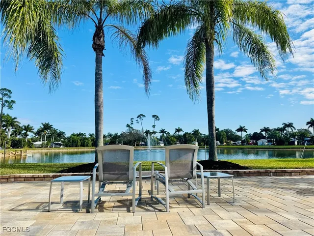 a view of a lake with a table and a chairs