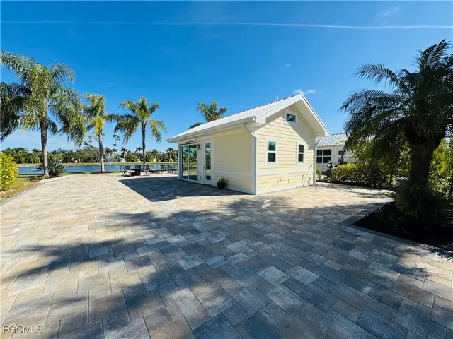 a view of a white house with a yard