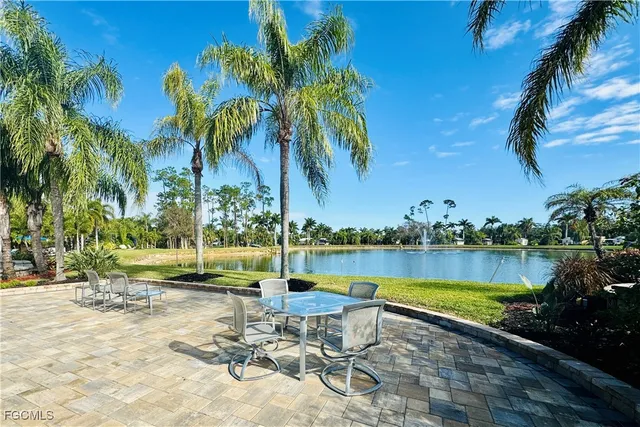 a view of a lake with a table and chairs