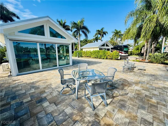 a view of a patio with table and chairs and potted plants