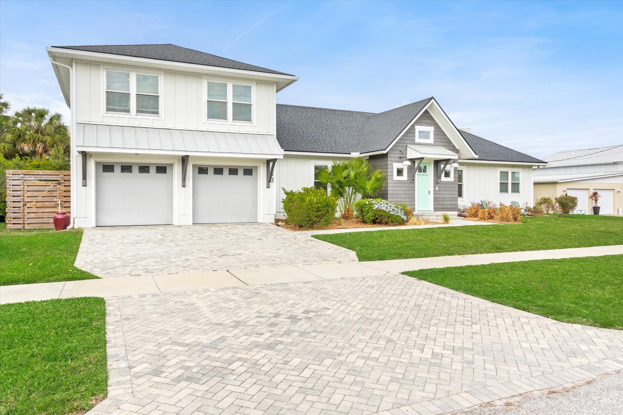 80 Ferrol Road St. Augustine, FL 32084 - Photo 52 of 61 a front view of a house with a yard and garage
