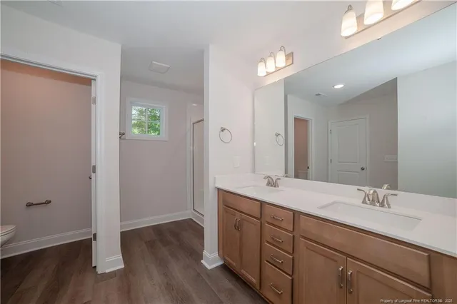 a spacious bathroom with a double vanity sink and a mirror