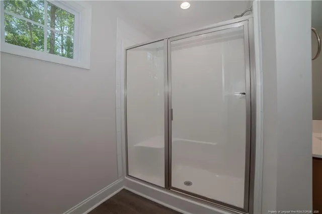 a bathroom with a glass shower door