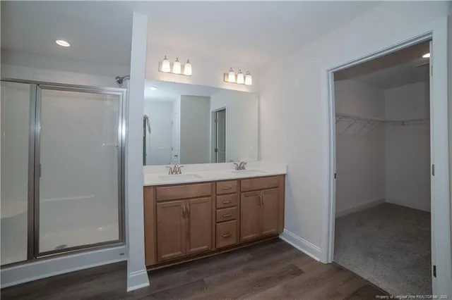 a bathroom with a double vanity sink and a mirror