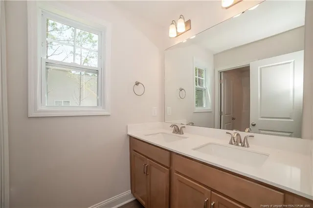 a bathroom with a sink a vanity and a mirror