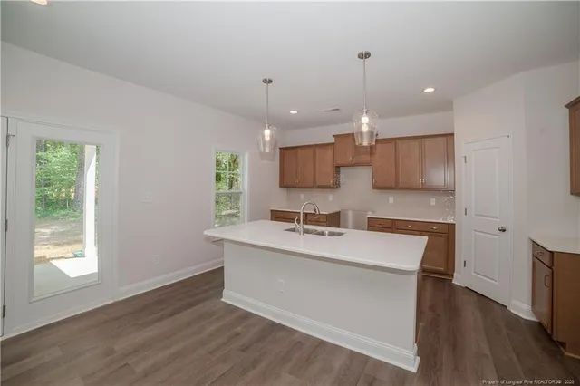 a kitchen with a sink cabinets stainless steel appliances and window