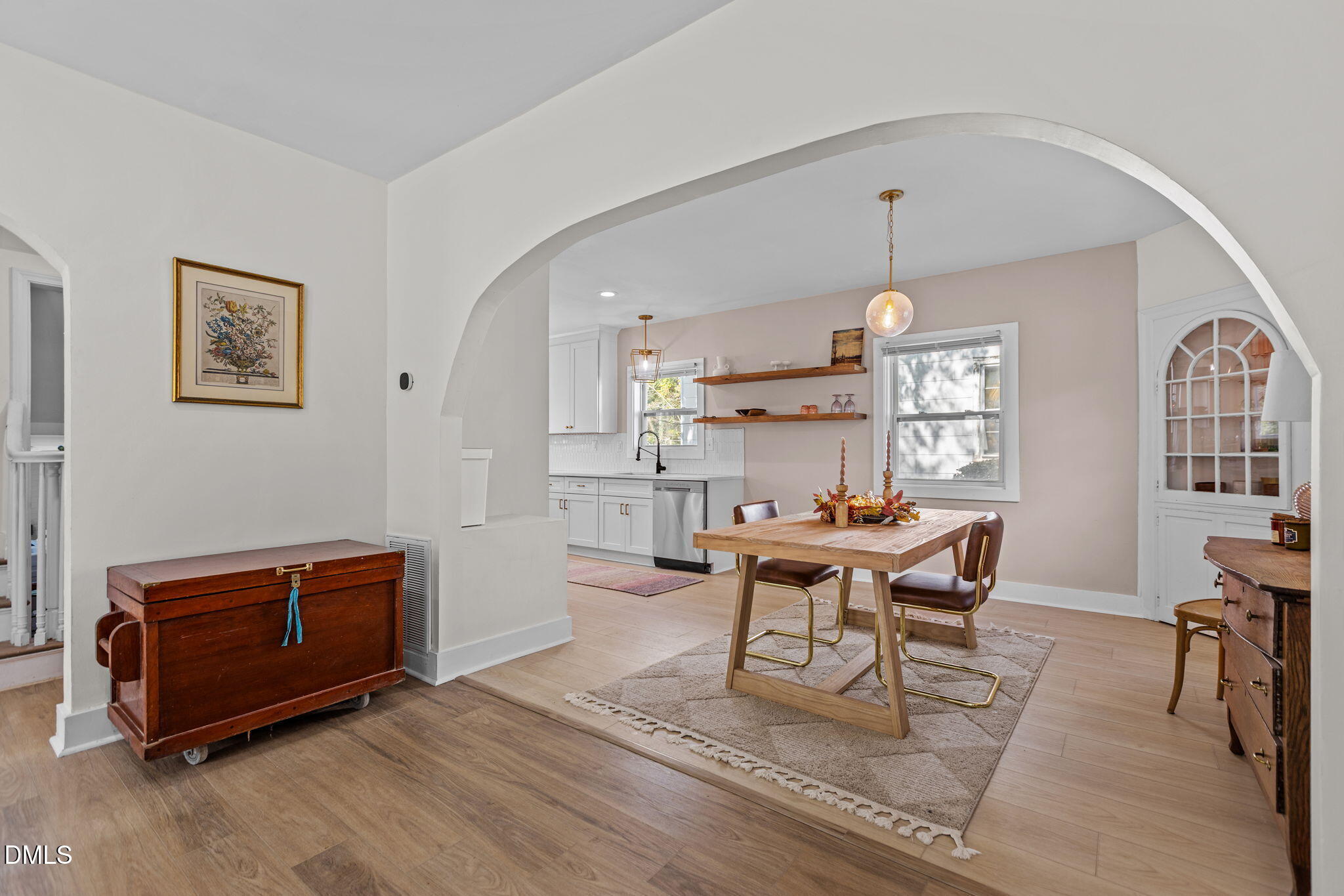 a living room with furniture a dining table and kitchen view